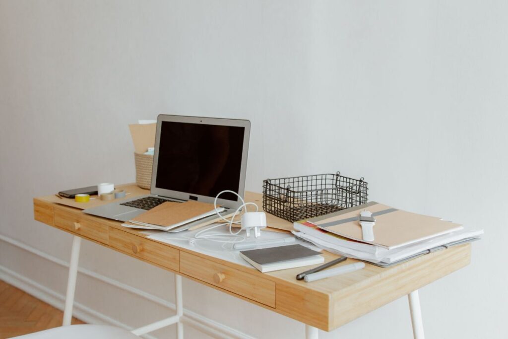 portable folding computer desk with white metal collapsible legs and laptop setup