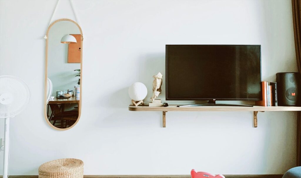 minimalist wooden wall mounted floating desk setup with no legs and flat screen monitor